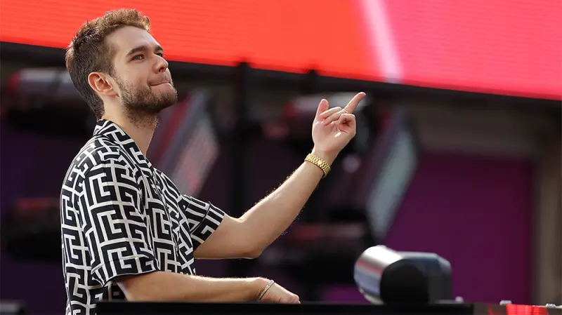 Zedd performing live at an EDM festival, embodying artistic expression